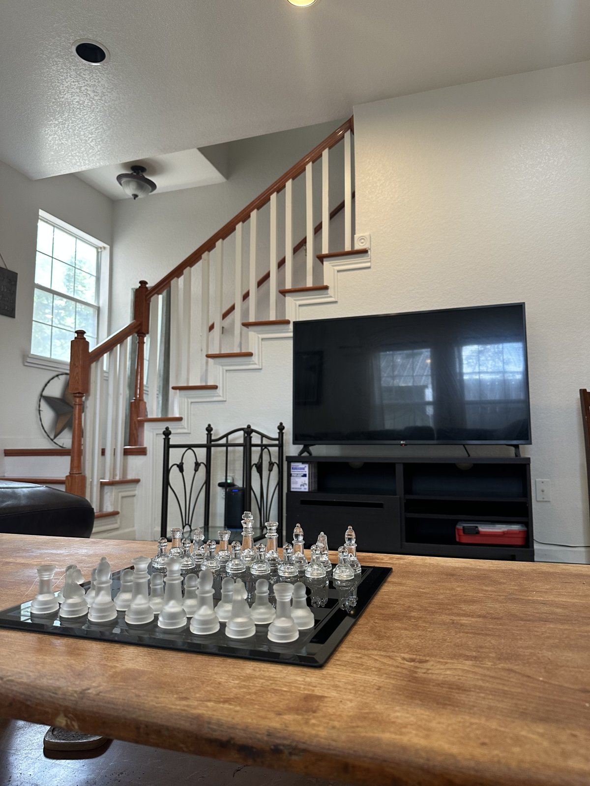 Staircase and common area with a glass chess set on the table
