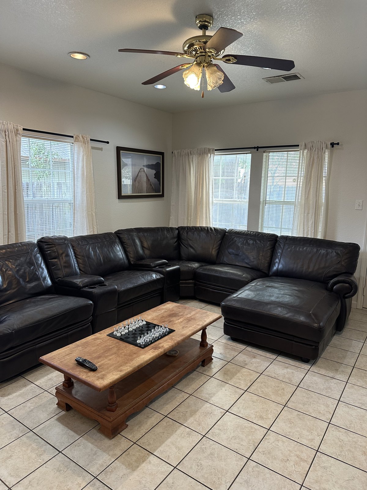 Living room with a large leather sectional and coffee table