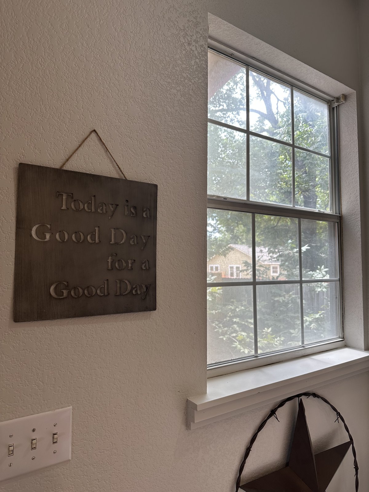 Sign reading Today is a Good Day for a Good Day beside a window