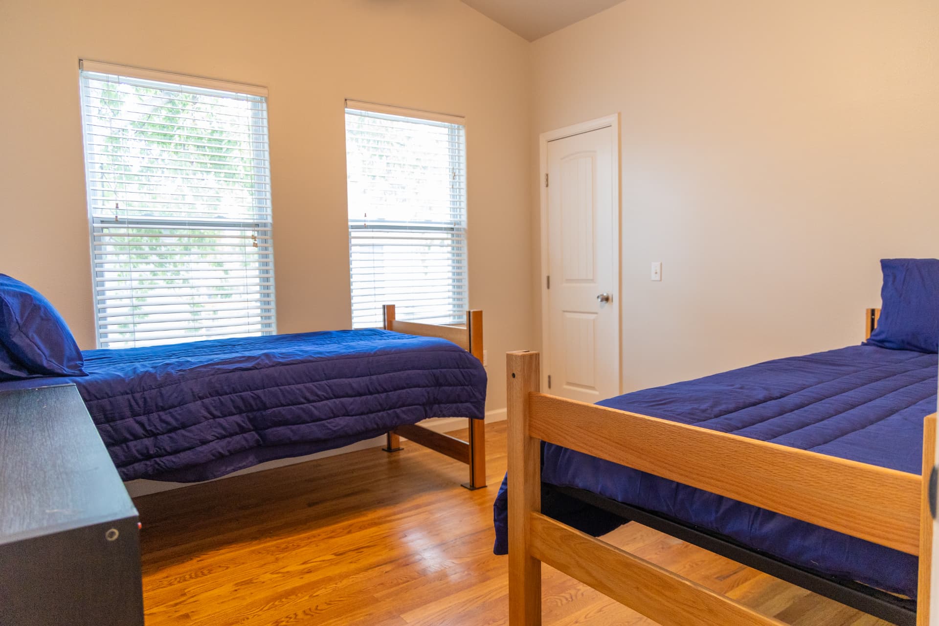 Bedroom with vaulted ceiling, two twin beds, and two windows
