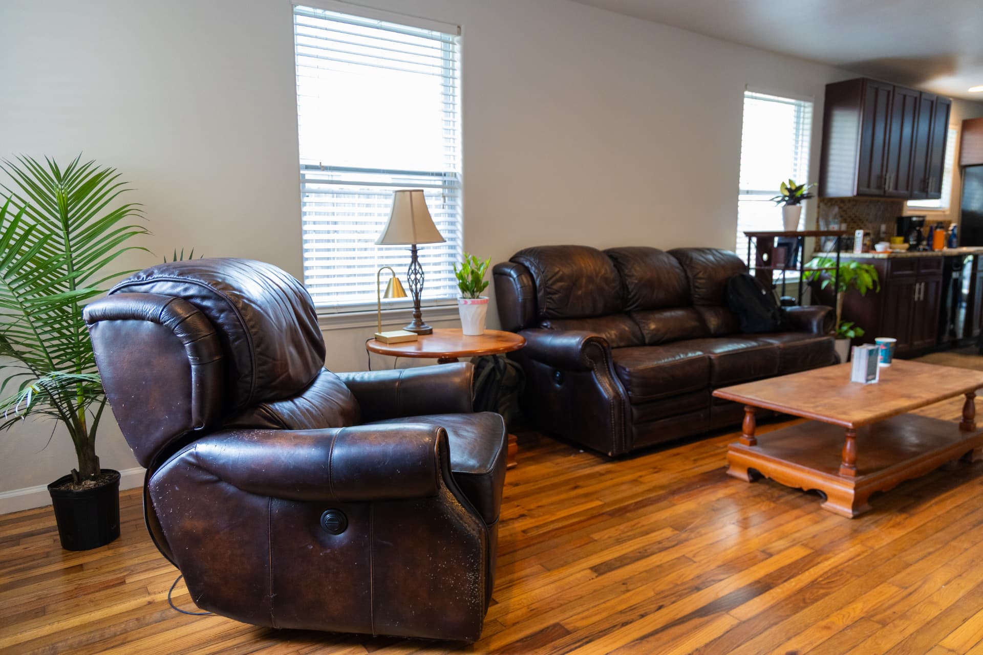 Living room with leather recliner, sofa, and coffee table