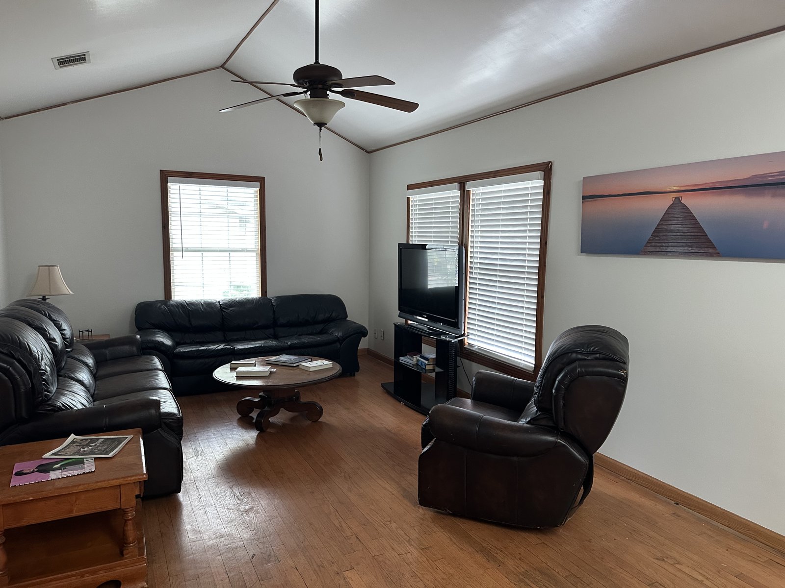 Second living room with vaulted ceiling, sofas, and television