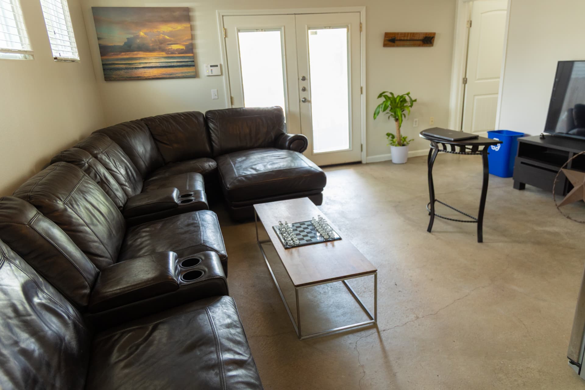 Lounge with sectional, chess board, and television
